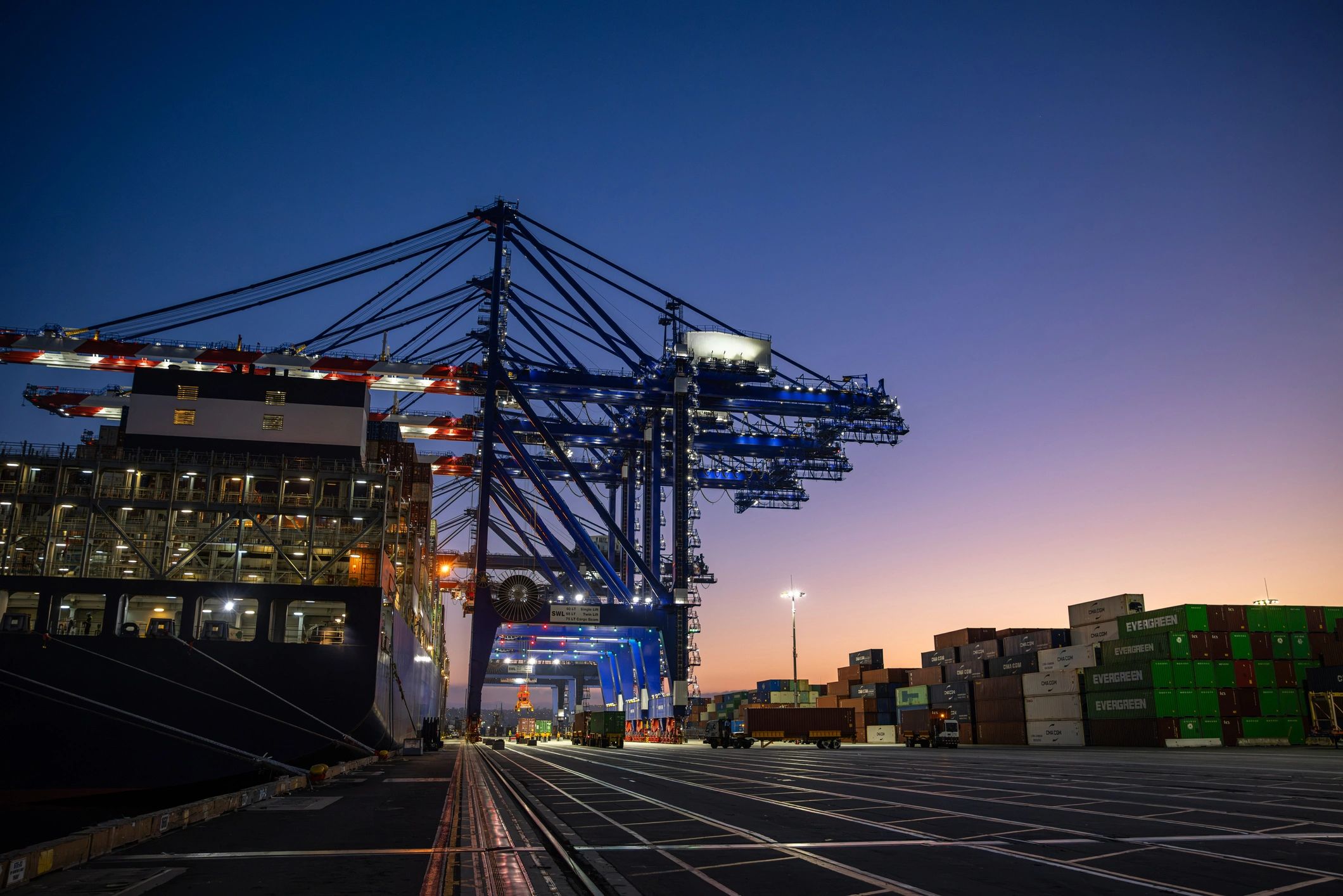 Container freight ship and gantry cranes at an international cargo terminal