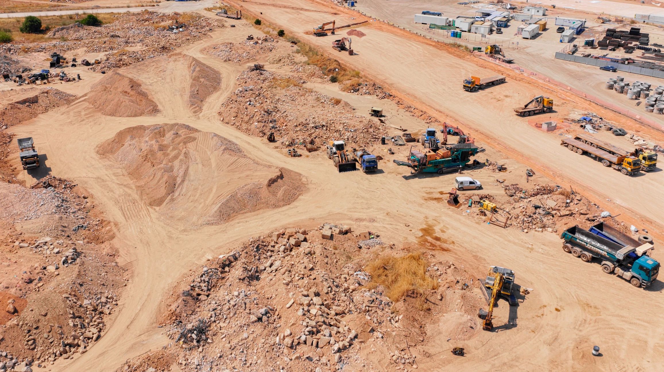 Heavy equipment and excavated earth at a large civil construction site